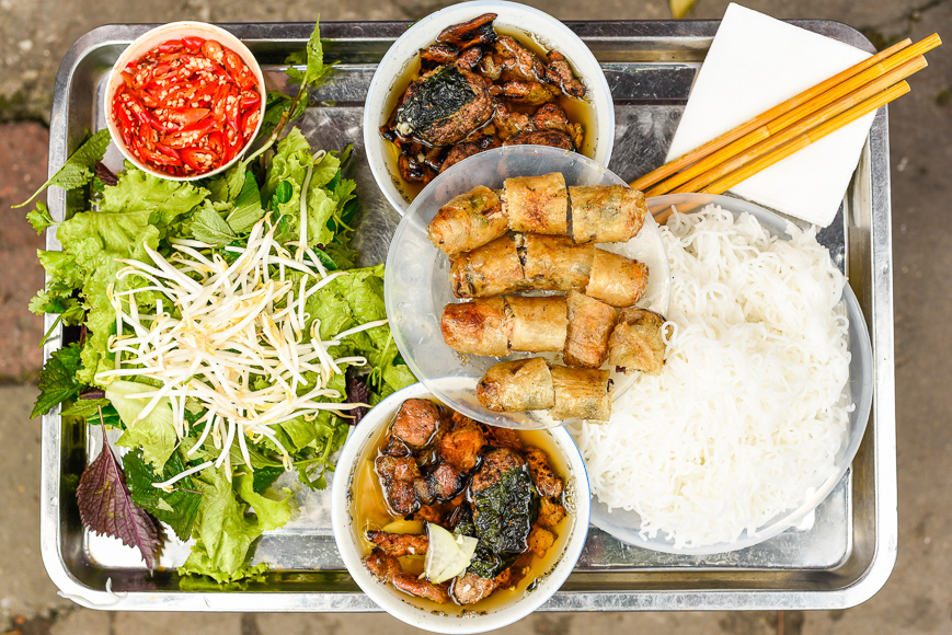 Bun Cha served on the sidewalk in Hanoi.